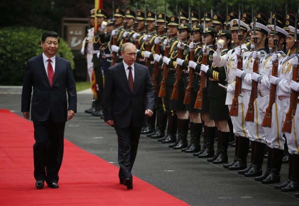 Russia's President Putin and China's President Xi review an honour guard during a welcoming ceremony at the Xijiao State Guesthouse ahead of the fourth CICA summit in Shanghai