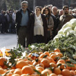 People line up for fruits and vegetables freely distributed by farmers during a protest against high production costs outside the Agriculture Ministry in Athens