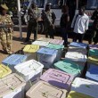 Kenya Wildlife service personnel stand in front of boxes filled with ballot papers at a tallying center in Nairobi