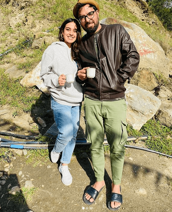 All of us are vying for vacations, aren’t we? Even though Corona is still here and isn’t going anywhere unfortunately but coming out of the lockdown and the quarantine period, we all want to breathe that fresh mountain air. And our celebrities are the first ones to rush to the mountains to get a much-deserved time off. Iqra Aziz and Yasir Hussain are also one of those who never leave any time to take some time off for a retreat up north. One of the most discussed couples of the Pakistani entertainment industry is once again vacationing in the Northern areas, and we are here to tell you more about it. Where Are Iqra Aziz & Yasir Hussain? The couple is in Naran right now taking some time off in fresh mountain air. How do we know about that? Even though Yasir has posted about it (more on it coming soon), Iqra also gave a sneak peek in her Instagram post. The actress just wrapped up the shooting for her drama Raqeeb Say on HUM TV, and while posting about that she also mentioned that it is now time for her to blow off the work steam and vacation a bit with her husband. Here is what she wrote: “Schedule over! Jumping with joy for its now time to have some fun and enjoy holidays👏🏻 Thank you, #Lahore - you've been very kind. “#north see you soon “#RaqeebSy #HumTV” Here is her Instagram post: Yasir’s Latest Post On Instagram: After this post, we did not get much from the duo in terms of updates, but we all know how spotty the internet connection is up North. But, the actor posted a picture yesterday with Iqra both posing in a rocky mountainous area, sipping the Chai. Here is what he posted on Instagram: Well, these pictures make me want to pack my bags and travel up North, because we all deserve a vacation after one hell of a year we had, this year. Let’s just make our travel plans and stay updated with these two to see what they are up to. At least, we get to travel virtually somewhere through their stories anyway. Let us know in the comments section is seeing their pictures make you want to go on a vacation or not? 