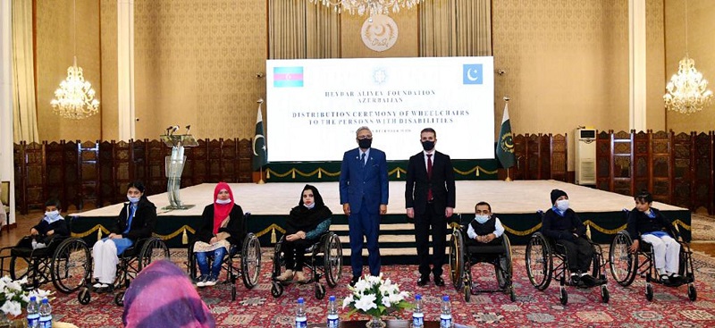 Disabled people - The Embassy of Azerbaijan in Islamabad has gifted 100 customized wheelchairs to the disabled people in Pakistan at an event held at Aiwan-e-Sadr in Islamabad on Tuesday. The event was attended by President Dr Arif Alvi, First Lady Samina Alvi, Azerbaijan’s Ambassador Ali Alizada and a number of disabled persons including children. In his address at a Wheelchair Distribution Ceremony, the president said that persons in the society deserved access to education and employment as their “equitable right, and not as charity”. “The State is responsible to transform the society in a way that it accepts and mainstreams the differently-abled persons in all segments of life,” the president said. President Arif Alvi emphasized on adopting inclusive approach towards persons with disabilities by providing them education at regular schools instead of secluding them at special institutes. The president said that persons with physical, visual or hearing impairment could be easily absorbed into the normal school system, to be followed by targeted skilled training for their accommodation at workplace. “It is the time to shun the stereotype approach towards disabled persons and give them opportunities and access to facilities,” he said. Dr. Arif Alvi stressed proper implementation of 2.5 percent disabled quota in jobs and ensuring training through the National Vocational and Technical Training Commission (NAVTTC) and the Technical Education and Vocational Training Authority (TEVTA) for effective results. The president mentioned that of the social welfare agenda initiated by him and his wife, the uplift of disabled people was a priority and ‘a subject close to their hearts’. President Arif Alvi said that the government under the Ehsaas project had registered two million people with disabilities for disbursement of stipend while banks had also launched schemes to offer loans for special persons to carry out small and medium enterprises. The president mentioned that the Chairman Capital Development Authority (CDA) had assured him that all pavements in Islamabad would get ramps by March besides 250 public parks to also become wheel-chair enabled in near future. President Arif Alvi said that the government was working with the business community of Islamabad, Lahore and Karachi to make accessible the market places for disabled. Dr. Arif Alvi said that a survey revealed that around 15 percent of the population of Pakistan was suffering with different forms of disabilities, which needed to be given an access-friendly environment in buildings and public places. In addition, the president pointed that lack of facilities at public places forced the families to confine their disabled members at homes. The president extended sincere gratitude to Azerbaijan for gifting wheelchairs to the disabled people of Pakistan, saying the precious gesture of compassion was a belief in respecting the rights of such people. President Arif Alvi lauded Ambassador Ali Alizada for his commendable job of contributing to the socio-welfare development of Pakistan through launching projects in fields of education, culture, environment and health including providing assistance to the Thalassemia Centre in Islamabad. The president mentioned that Pakistan and Azerbaijan enjoyed friendship based on common religion and culture of “caring for weaker segments of society”. President Arif Alvi also congratulated Azerbaijan on liberation of its territories captured by Armenia in the Nagorno-Karabakh conflict. Azerbaijan’s ambassador Ali Alizada said that the memorable event of gifting of wheelchairs was manifestation of the support the two countries gave to the rights of persons with disabilities. Ali Alizada said that the proposal by President Dr. Arif Alvi to Azerbaijan for customized wheelchairs depicted his personal commitment to the welfare of disabled people. President Arif Alvi and Begum Samina Alvi also took round of the exhibition of handicrafts and paintings made by children with disabilities aging 12 to 15 years and appreciated their talent. With majority of the audience on wheelchairs, the president and the first lady approached each individually and greeted them with their words of encouragement and appreciation. 