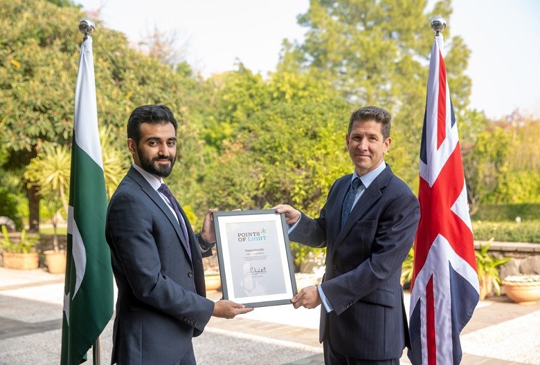 Hamza Farrukh - Her Majesty Queen Elizabeth II has recognized Hamza Farrukh, representing Pakistan, as the 129th Commonwealth Point of Light in honour of his exceptional voluntary service providing clean water to local communities in Pakistan. The British High Commissioner Dr Christian Turner presented the award to Hamza Farrukh at a ceremony arranged by the British High Commission here on Tuesday. The Commonwealth Points of Light is a continuation of this programme with a special series of awards recognizing inspirational volunteers throughout the Commonwealth, coinciding with the UK being the Chair-in-Office of the Commonwealth for the next two years. One volunteer from each of the 53 Commonwealth countries was recognised in the days leading up to the Commonwealth Heads of Government Meeting in April 2018. Hamza Farrukh runs a charitable project ‘Bondh-E-Shams’ (droplets of sunshine) which is serving over 45,000 people across 13 remote Pakistani villages. Hamza began Bondh-E-Shams’ as a college project in March 2014, focusing on one particular Pakistani village. He was then awarded further funding to set up the charity, which has now provided over 10 million cups of water to people in remote communities in Pakistan through an environmentally friendly, solar-powered water extraction and filtration system. Hamza Farrukh said: “At Bondh-E-Shams, we have promised to take on the global water crisis: lack of access to safe water in large swaths of developing nations is symptomatic of the numerous structural disadvantages faced by the global south. My team and I realise the responsibility we have towards the 1.2 billion people who go to bed thirsty each night, and are dedicated to this lifelong fight.” The British High Commissioner, Dr Christian Turner, said: “I am delighted to present Hamza Farrukh with the Commonwealth Points of Light award for his exceptional voluntary service and ingenuity in helping to provide safe drinking water to tens of thousands of Pakistanis. Her Majesty The Queen has recognised Hamza as Pakistan’s Point of Light for delivering a significant impact on the lives of others.” Bondh-E-Shams has leveraged the power of smart-tech and I-o-T in flagship solution called the “Oasis Box:” a transportable, solar-powered water filtration unit that removes 99.99% of water contamination and can be installed in under a record 7 minutes, anywhere in the world. The Points of Light award recognizes outstanding volunteers every day of the week people whose service is making a difference in their communities and whose story can inspire others to creative innovative solutions to social challenges in their own communities and beyond. The Points of Light began in America under President George H. W. Bush and today over 6,000 US Points of Light have been recognised. The scheme has the support of all living US Presidents. Since 2014, the UK Prime Minister has been recognizing a daily Point of Light from the UK, with more than 900 volunteers now recognised. Following the success of this programme, Her Majesty The Queen decided to continue this work and award one volunteer from each Commonwealth country every week leading up to the Commonwealth Heads of Government Meeting in Rwanda in 2020.