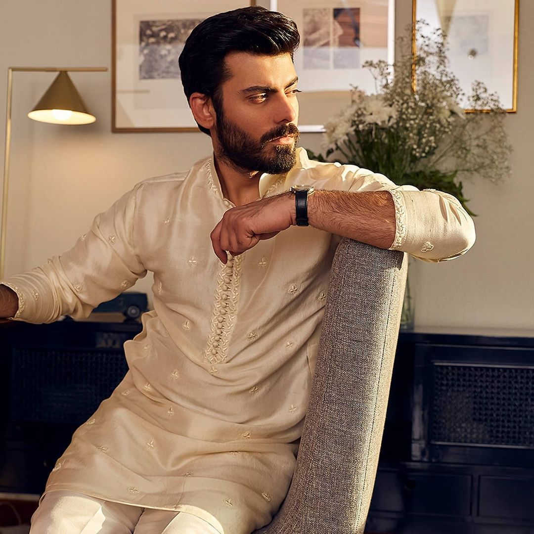 Our heartthrob Fawad Khan has never missed a chance to impress fans as he is the true definition of perfection. Whether it is about acting, singing, or modelling, Fawad has set a standard that is definitely unbeatable. That's the reason fans always fall in love with him and his work. His dramas like Humsafar, Zindagi Gulzar Hai, and Dastan introduced a whole new Fawad Khan on screens. No one could ever imagine that he will dive so deep into every character that will make those dramas blockbuster hits. Well... we cannot deny the fact that Fawad is dashing and magnetically grabs attention specifically from his female fans. Same is the case this time as we got to see her latest photoshoot making rounds on social media. Let's have a look at these clicks!  Fawad Khan Leaves Fans Flabbergasted in Latest Photoshoot!   Fawad's talented wife Sadaf Fawad Khan is showing her creativity in the bridal collection and we are already in love with the appeal of these dresses. The way she has hooked simplicity and exclusivity in her outfits have made us think of new ideas in bridal wear. Check out these fascinating clicks as Fawad leaves his fans flabbergasted along with model Kiran Malik. Take a look!            The dull yet fancy touch on these dresses has made it something different when it comes to the bridal collection. Sadaf has used her creative sense at the best to bring out something like never before. On the other hand, Fawad has exhibited a white dress for the groom with light balancing fancy touch to make it classy. It is more than a treat for eyes as Fawad knows well how to enhance the grace of an outfit.  So, what do you think about the latest photoshoot of Fawad Khan? Don't forget to share your valuable feedback with us!
