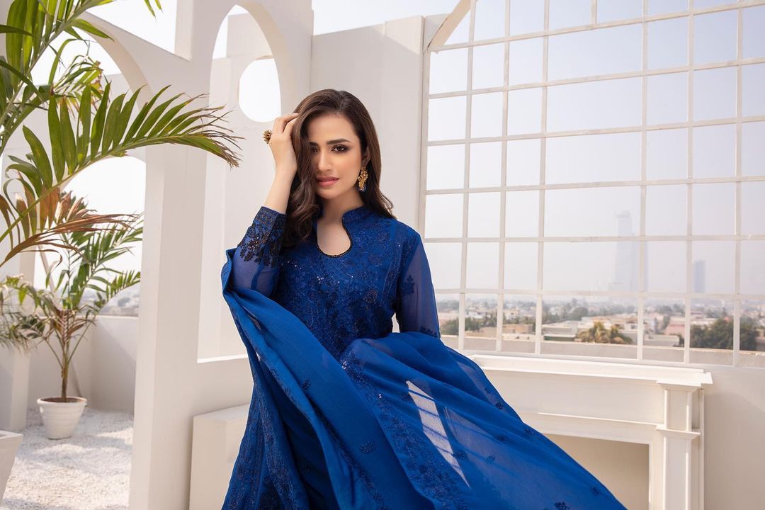 The ever-gorgeous Sana Javed has set the internet on fire after a good long time with her latest mesmerizing clicks. As we know that Sana was seemingly on a break after her marriage, however, now she is turning on the heat with her photoshoots. She is so beautiful and makes sure to flaunt elegance in whatever she wears. Let's have a look at the latest photoshoots of Sana Javed as she leaves her fans spellbound!  Sana Javed Sets Internet on Fire with Latest Mesmerizing Clicks!   Gear up for the sizzling hot and mesmerizing photoshoots of Sana Javed as she flaunts perfection in all aspects. It is literally so hard to take away our eyes. Check out these photos!  Elegant Blue Dress!  Here Sana is wearing an elegant blue dress that is made into perfection. The finest embroidery touch has enhanced the overall look of this outfit. Moreover, the tassels on the dupatta are a perfect addition to the design of this wear. Have a look!       Sana Javed in Exquisite Black!   So, this dress is a creative blend of traditional and modern design in black fabric with a touch of red and off-white. The designer has keenly worked on its embroidery to make it something stand out this season!       Peach Fantasy!   Peach is a colour that makes one look enchantingly gorgeous like a fairy from the fantasy. Well... Sana Javed is looking like a princess here and the dress she is wearing is all about being classy as per the latest trends!       Classy Blue!  Another from the blue family, here we have Sana wearing from the magnificent collection of lawn that is literally outstanding. The classy blue colour of this dress itself celebrates the essence of the approaching season. Moreover, Sana has carried it so confidently that makes it the best formal wear!       Lovely Red!   Red never goes out of fashion and this shade that Sana Javed is exhibiting is one of its kind. There can be no other best way to celebrate the arrival of spring/summer than wearing this beautiful red attire that defines perfection. Check out these clicks!       Soft Pink!   Pink is the fancy colour that makes one feel youthful and fresh on all occasions and in every weather!       Classic Printed Dress!   This dress is simple yet elegant that you can wear at formal and informal gatherings. Make it a must addition to your lawn dresses.      Glamorous Gold!   This dress is one of the masterpiece attires from the collection that you must have this season. Sana is exhibiting the dress while making it significant as something you should wear at formal gatherings.      Bright Yellow!   Yellow is a revitalizing colour for both the summer and winter seasons. If you want to feel fresh and live again in every moment of life, it's to have this dress and make it happen!       Mesmerizing Purple!   Purple is another colour of celebration that makes one stand out from the crowd. The fancy feel of this colour is unmatchable while the luxurious feel of such a dress is out beyond explanation. This graceful wear is best to wear on formal and informal occasions.       So, what do you think about these latest mesmerizing photoshoots of Sana Javed? Don't forget to share your valuable feedback with us!