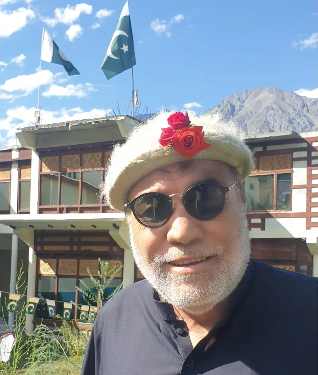 Iqbal Balti sitting on the lawns of Karakoram Lodge Khaplu